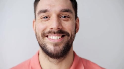 Man Smiles Happily in Close Up Headshot