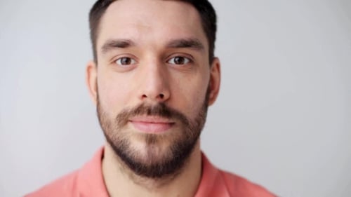 Man Smiling Close-Up in a Studio Setting