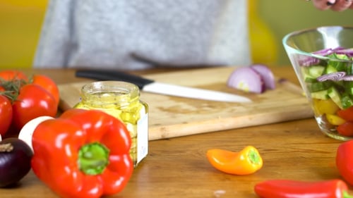Woman Prepares Fresh Salad with Vegetables