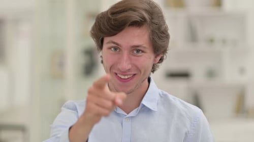 Casual Young Man Pointing Finger and Inviting