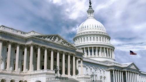 United States Capitol Building with Waving American Flag and Moving Clouds