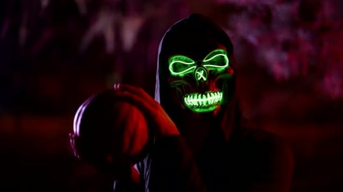 Grim Reaper Holding a Pumpkin in the Dark