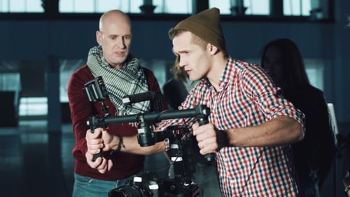 Film Crew Gathers Around Camera Equipment