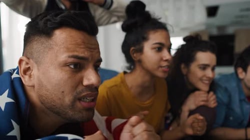Friends Watch Sports Game with American Flag