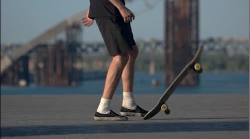Person Does a Skateboard Trick in Urban Setting
