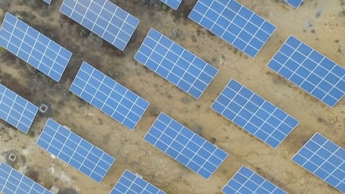 Aerial View of Solar Panels in a Field