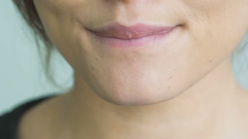 Young Adult Woman Licking Dry Lips