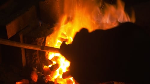 Flames and fire in dark stone container