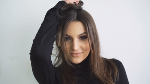 Beautiful Woman Posing and Playing With Her Hair