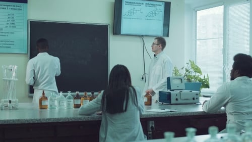 Students Learning Chemistry in Brightly Lit Laboratory