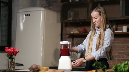 Charming Woman Blending Beet Smoothie with Blender