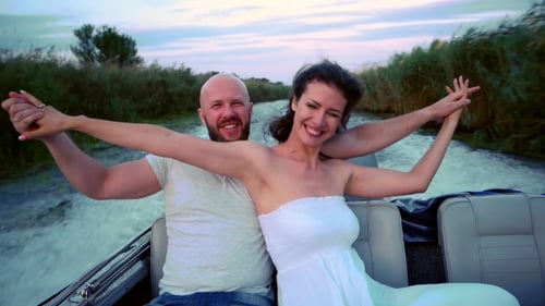 Romantic Couple Boating at Sunset on a Lush River