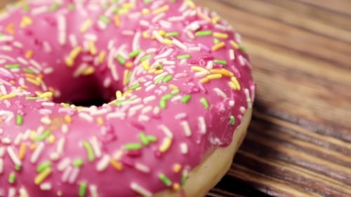 Pink Frosted Donut with Sprinkles Close Up