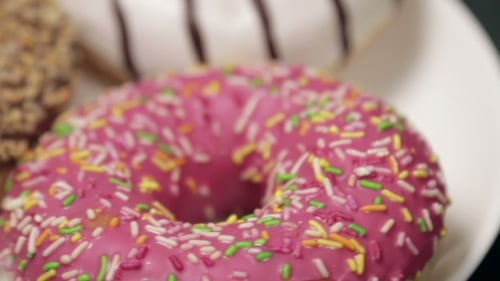 Colorful Donuts with Frosting and Sprinkles Close Up