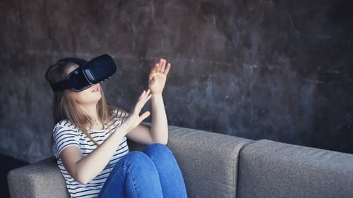 Woman Using Virtual Reality Headset on Couch