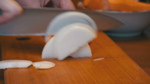 Slicing a White Onion on a Cutting Board