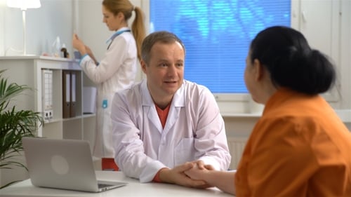 Doctor Comforting Patient in a Clinic Office