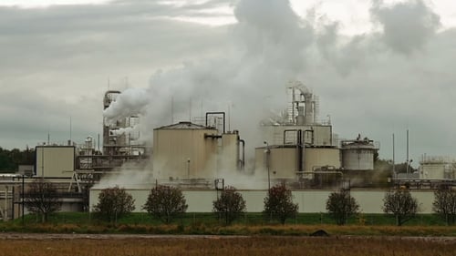Factory Smoke Stack and Pipes Puff Into Air