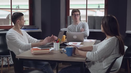 Frustrated Team Throws Papers in a Workplace Office