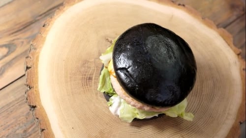 Charcoal Bun Burger on Wooden Slab