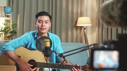 Young Adult Plays Guitar and Sings