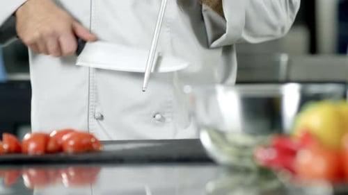 Male Chef Sharpening Knife in Slow Motion