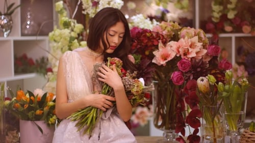 Elegant Young Woman Posing with Flowers