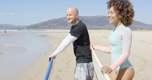 Cheerful Surfers on a Beach