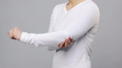 Adult Stretching Left Arm for Health and Fitness