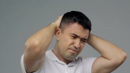 Man Holding Head in Pain Close Up