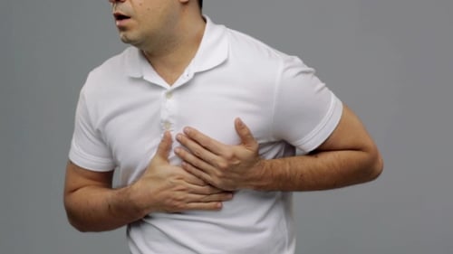 Man Holding Chest in Pain