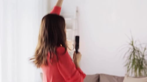 Woman with Hairbrush Singing and Dancing at Home 25
