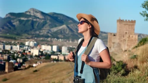 Pleasant Relaxed Travel Female Sunbathing Enjoying Sunset at Mountain Medieval Touristic City
