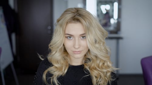 Young Blonde Posing for the Camera. A Close Shot of a Beautiful Face Photos. Hairdresser Made for