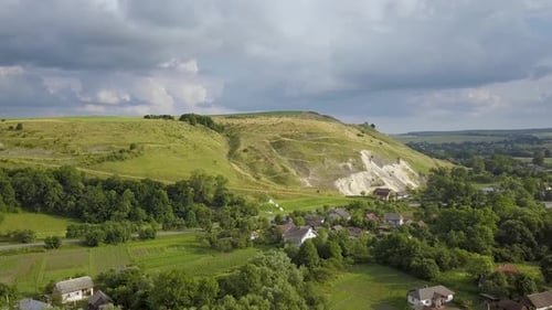 Aerial view of rural landscape. Green mountain hills with fresh meadows in summer.