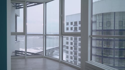 Young Adult Talking on Cellphone in Modern Apartment