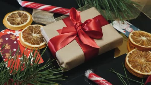 Brown Paper Gift with Red Ribbon on Table