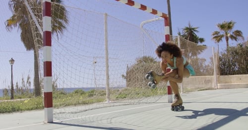 Young Fit Woman Riding in Roller Skates