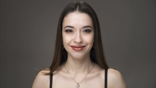 Beautiful Woman with Glamorous Makeup Posing in Studio