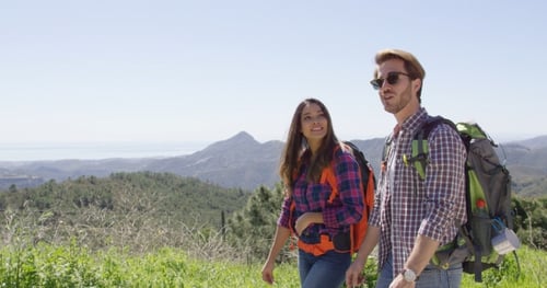 Hikers Exploring Mountain Scenery on Sunny Day
