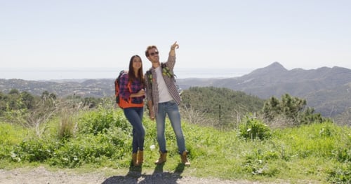 Young Adults Hiking in Rural Area with Mountain Views