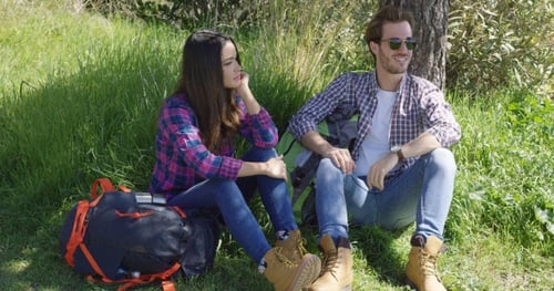 Young Couple Talking Outdoors Near Tree