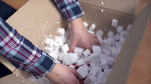 Person Opens Red Gift Package with Ribbon