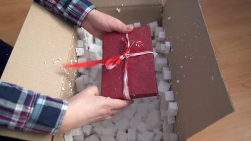 Opening a Birthday Gift Wrapped in Red