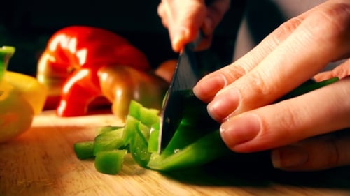 Amateur Female Cook Cutting Green Sweet Pepper