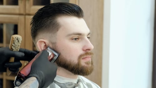 Brutal Bearded Customer Getting His Beard Cut By a Young Hairdresser