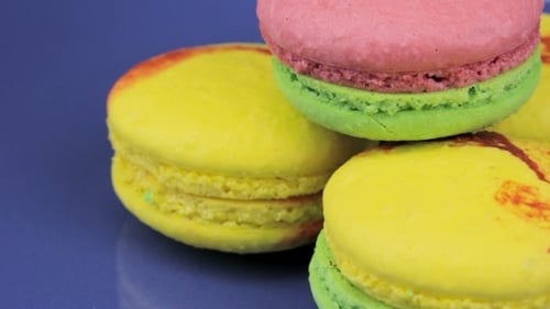 Pink, Yellow and Green Macaroon on the Blue Plate