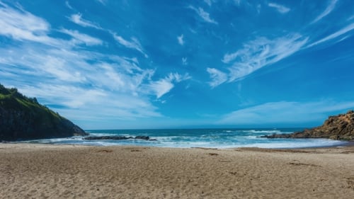 of Sandy Beach with Waves and Clouds