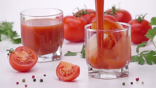 Pouring Tomato Juice Into Glass.