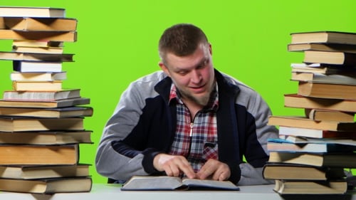 Guy That's Fun Reading and Leafing Through the Book. Green Screen